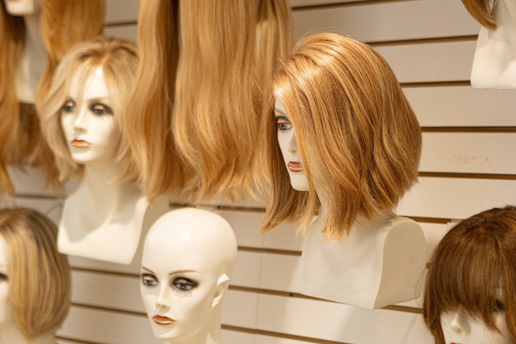 Human hair lace front wigs displayed in the Hair Enhancements of Pittsburgh salon.